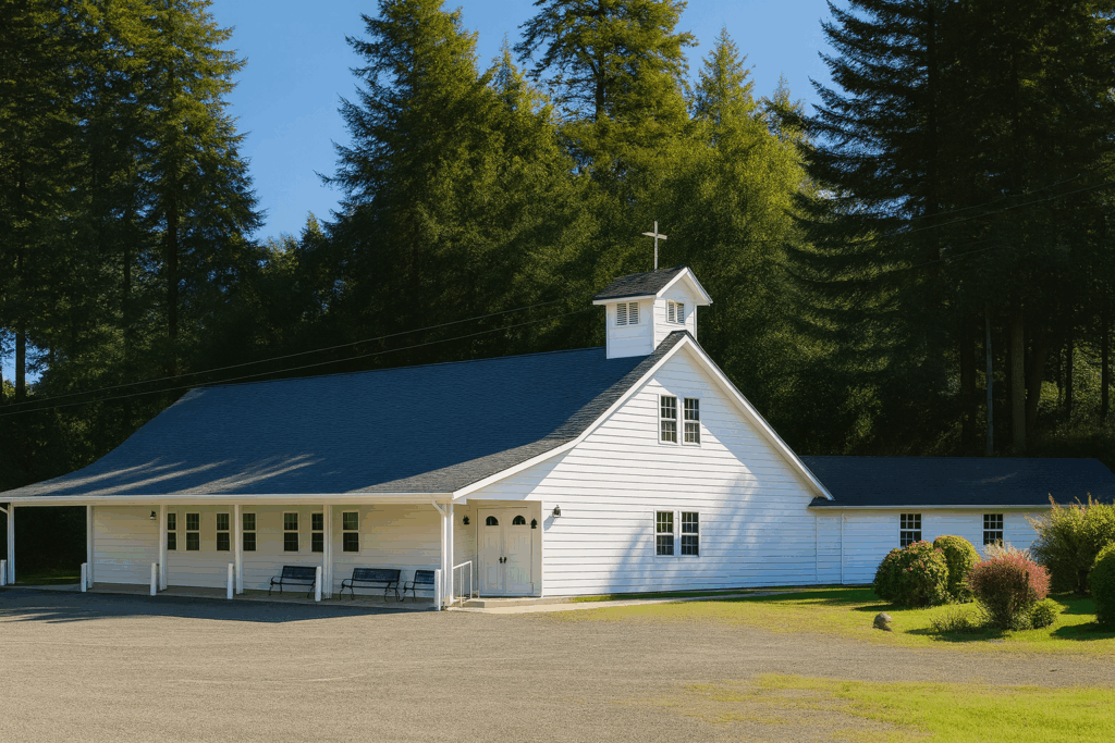 Traditional White Church Surrounded by Evergreens